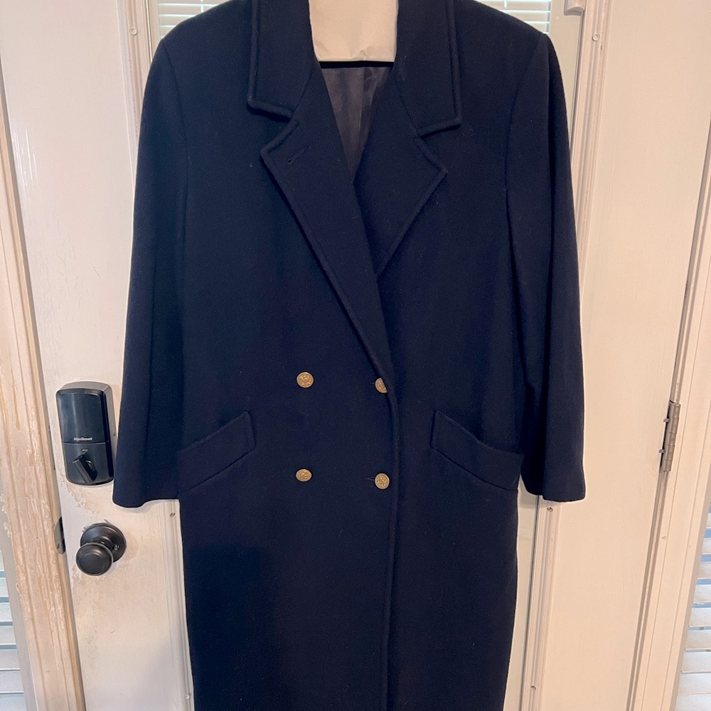 Double breasted, lined, full length wool coat.